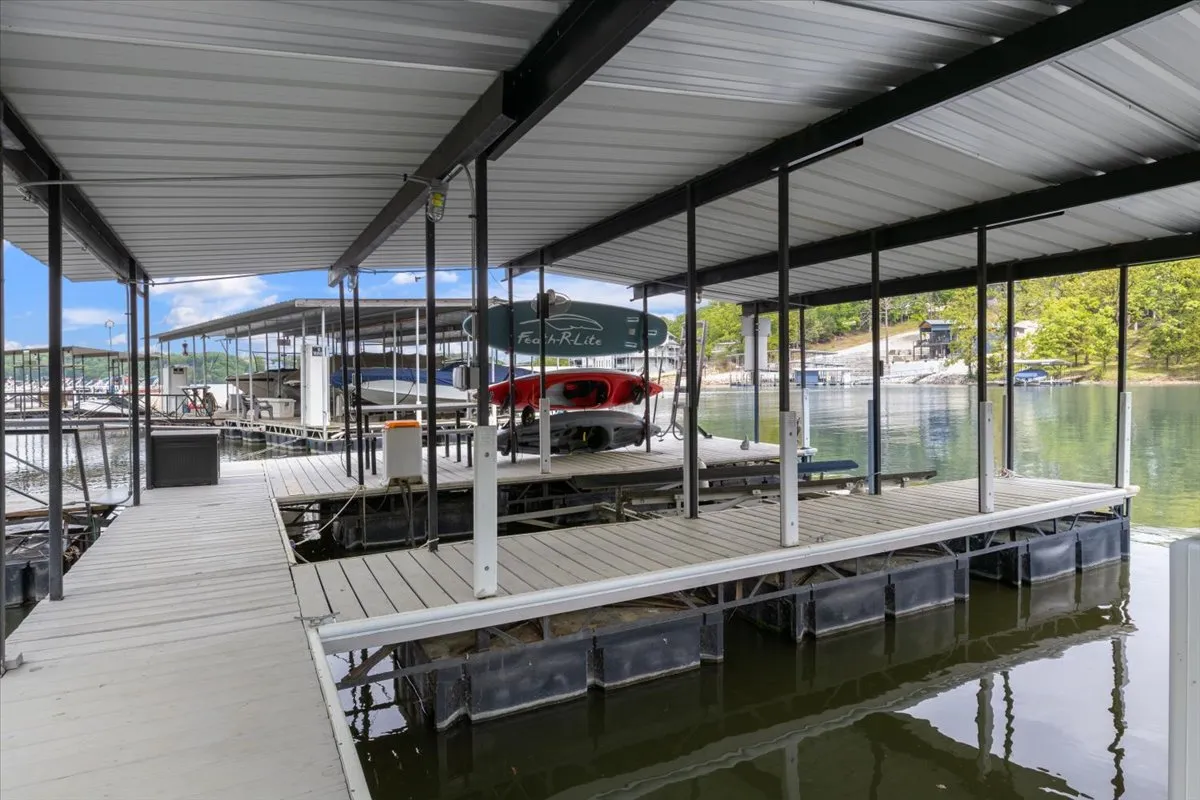 A peaceful dock scene with boats moored by the water's edge, the dock stretching out over a shimmering lake surface. The atmosphere is serene, with hints of sunset glow, inviting both relaxation and water activities.